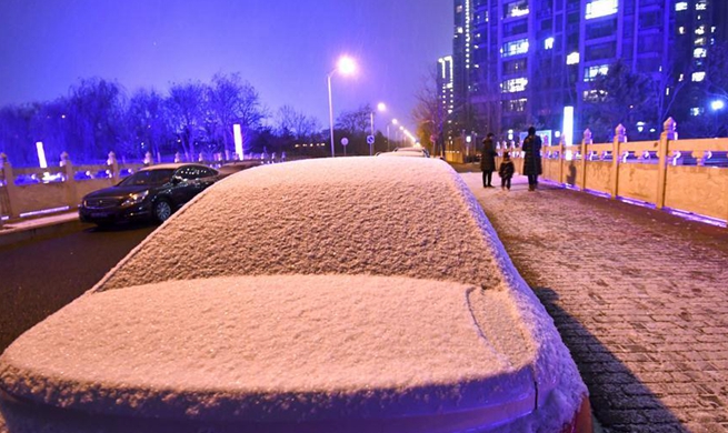 Snow falls in Beijing