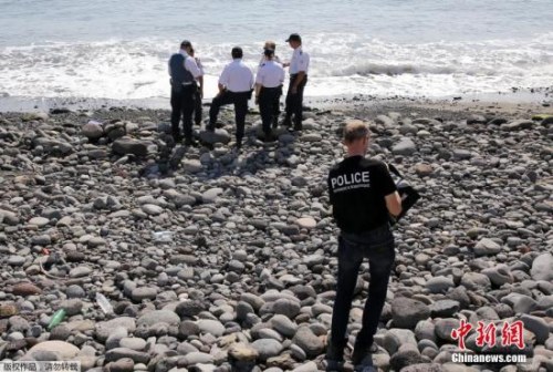 當?shù)貢r間8月2日，法屬留尼旺首府圣但尼附近的一處海灘上，警員正在現(xiàn)場對金屬殘片進行勘察。